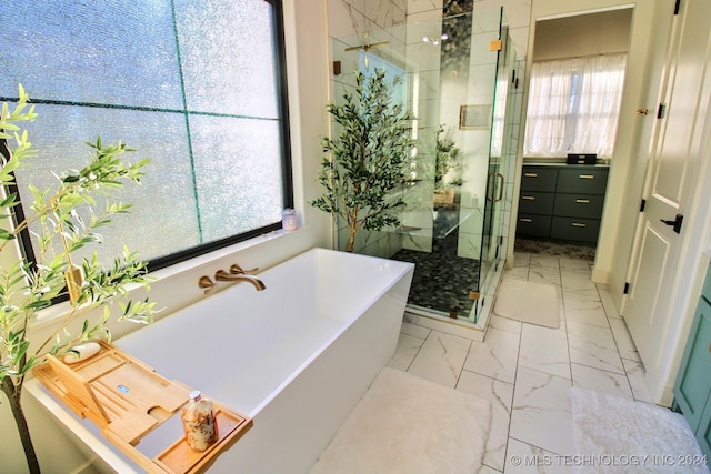 bathroom featuring shower with separate bathtub