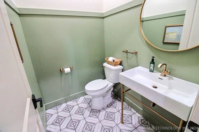 bathroom with tile patterned flooring and toilet