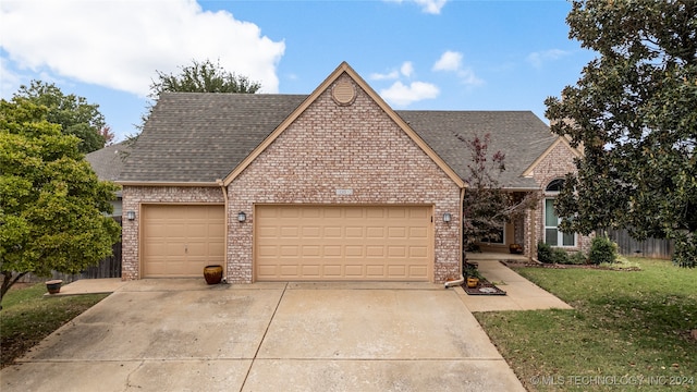 view of front of home with a garage and a front yard