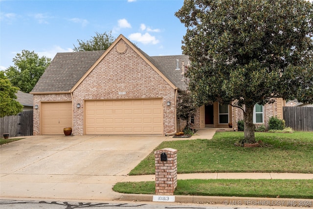 view of front of house featuring a garage and a front yard