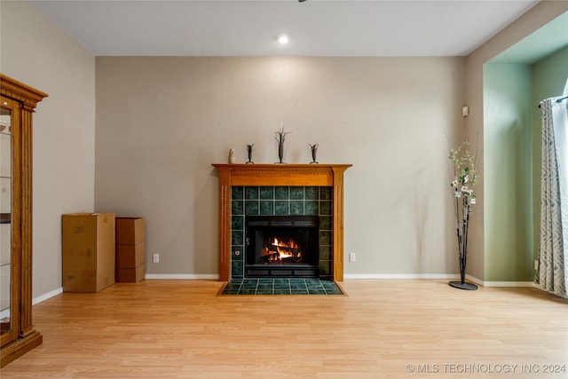 unfurnished living room featuring a fireplace and light hardwood / wood-style flooring