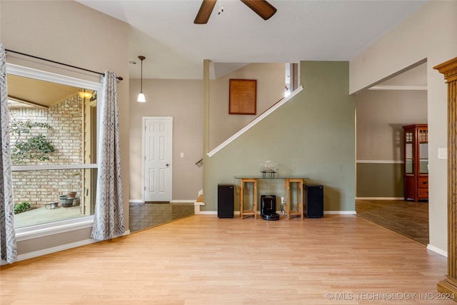 entrance foyer with ceiling fan, a healthy amount of sunlight, and light wood-type flooring