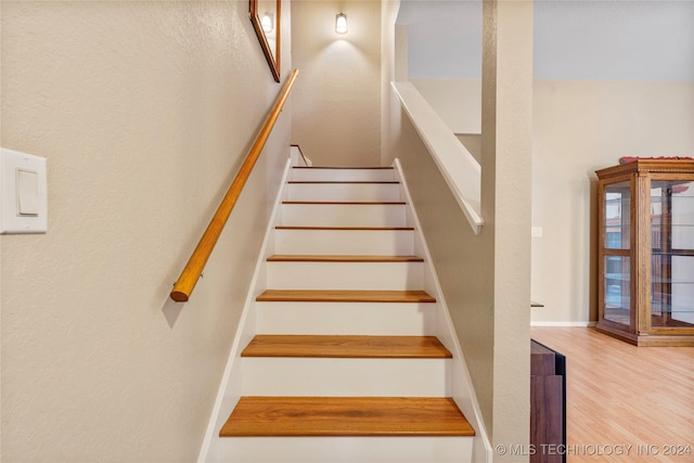 stairway featuring hardwood / wood-style floors