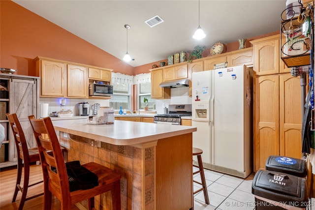 kitchen featuring stainless steel appliances, backsplash, a breakfast bar area, lofted ceiling, and a center island