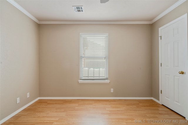 spare room featuring crown molding and light hardwood / wood-style flooring