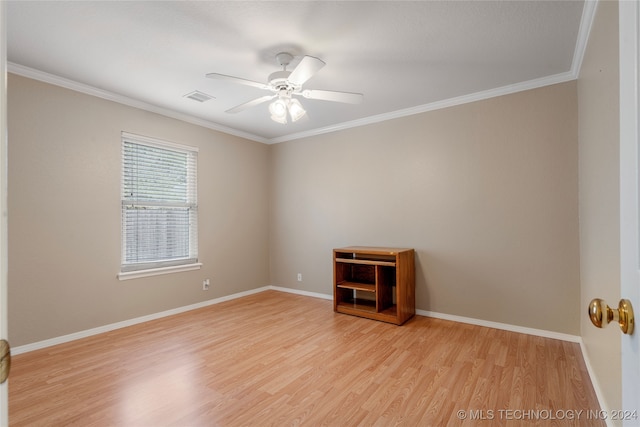 empty room with ceiling fan, light wood-type flooring, and ornamental molding