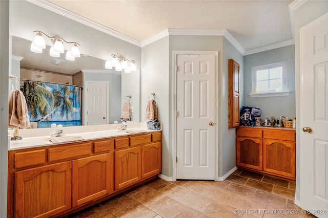 bathroom with vanity, a textured ceiling, and ornamental molding