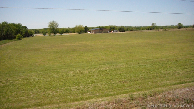 view of yard with a rural view