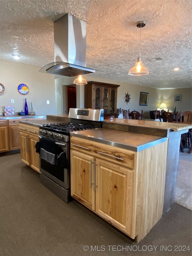 kitchen with stainless steel range with gas stovetop, hanging light fixtures, a textured ceiling, and exhaust hood