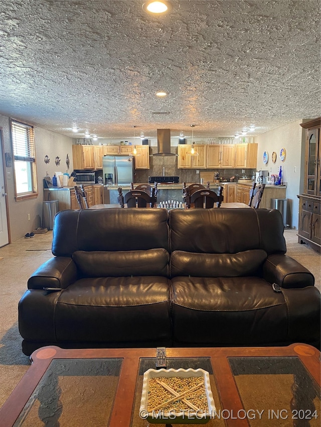 living room featuring light carpet and a textured ceiling