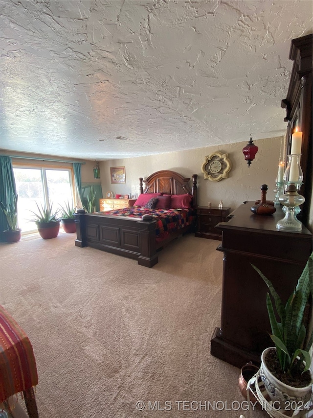 bedroom with a textured ceiling and carpet