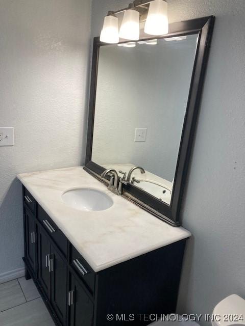 bathroom featuring tile patterned flooring and vanity