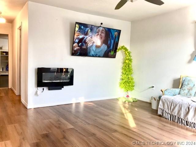 living room with ceiling fan and hardwood / wood-style floors