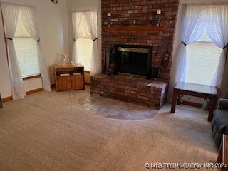 carpeted living room featuring a fireplace