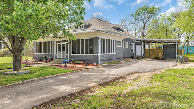 view of front facade with a sunroom and a carport