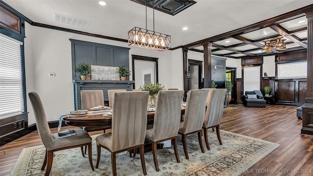 dining space with plenty of natural light, coffered ceiling, and dark hardwood / wood-style flooring