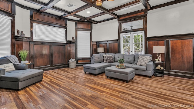 living room with coffered ceiling, hardwood / wood-style floors, and beamed ceiling