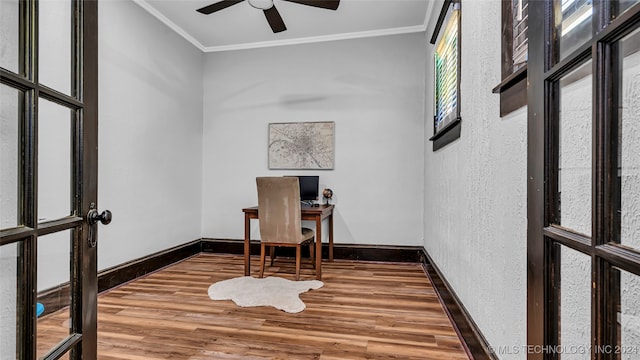 office area with ceiling fan, wood-type flooring, plenty of natural light, and ornamental molding