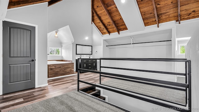 unfurnished bedroom with hardwood / wood-style flooring, lofted ceiling with beams, multiple windows, and wood ceiling