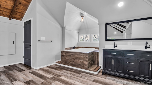 bathroom with hardwood / wood-style floors, a washtub, wooden ceiling, vanity, and lofted ceiling with beams