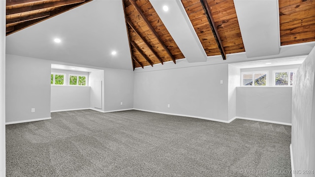 carpeted spare room featuring wooden ceiling, beam ceiling, and high vaulted ceiling