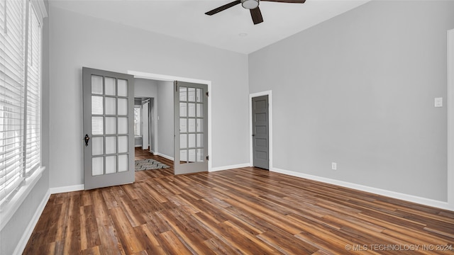 empty room featuring dark hardwood / wood-style flooring, french doors, and ceiling fan