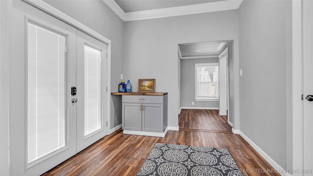 entryway with french doors, dark hardwood / wood-style floors, and crown molding