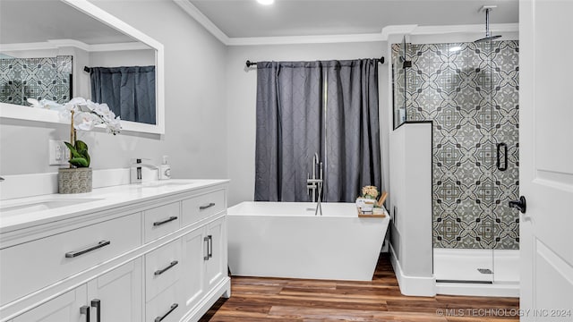 bathroom with independent shower and bath, vanity, wood-type flooring, and ornamental molding