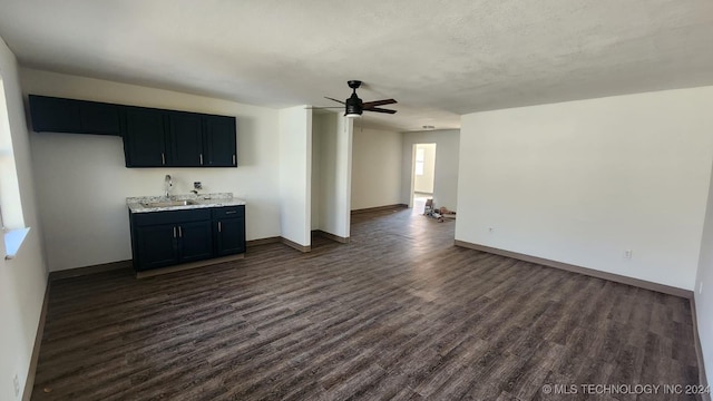 400 Tulsa Ave, Spavinaw, OK 74366 - interior space featuring dark wood finished floors, a sink, baseboards, and ceiling fan