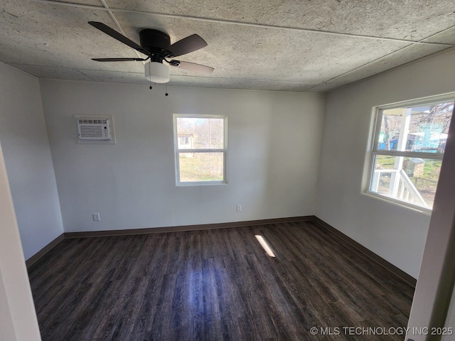 400 Tulsa Ave, Spavinaw, OK 74366 - spare room featuring baseboards, plenty of natural light, dark wood finished floors, and a wall mounted AC