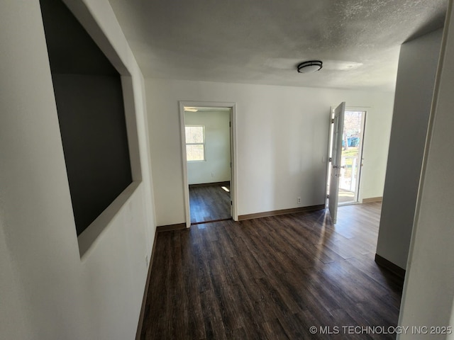 400 Tulsa Ave, Spavinaw, OK 74366 - interior space featuring dark wood-style floors, plenty of natural light, a textured ceiling, and baseboards