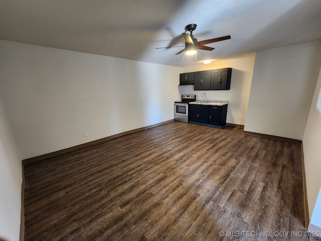 400 Tulsa Ave, Spavinaw, OK 74366 - unfurnished living room with dark wood-style floors, baseboards, a ceiling fan, and a sink