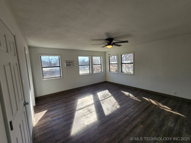 400 Tulsa Ave, Spavinaw, OK 74366 - unfurnished room with baseboards, dark wood-style floors, and a ceiling fan