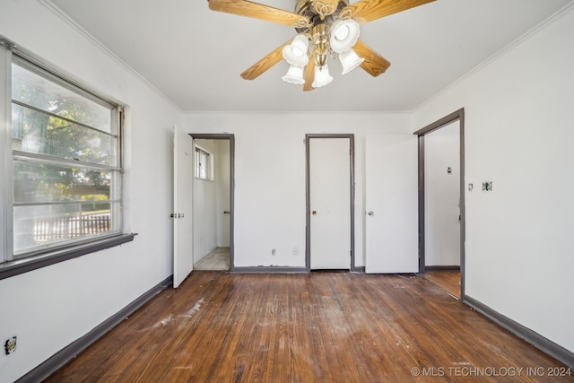 unfurnished bedroom with ornamental molding, dark wood-type flooring, and ceiling fan