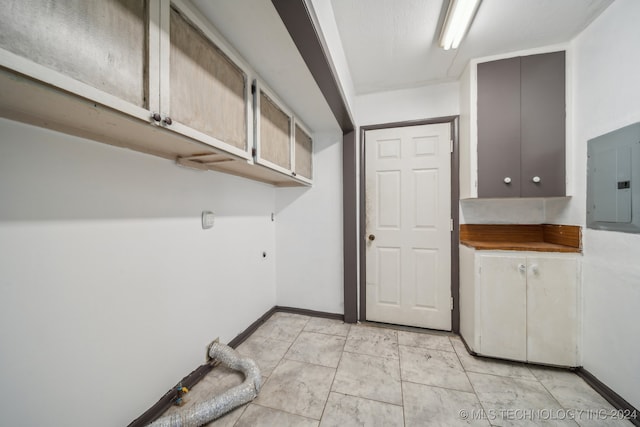 laundry room featuring electric panel, cabinets, and hookup for an electric dryer