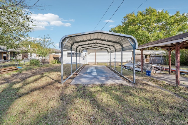 view of car parking featuring a lawn and a carport