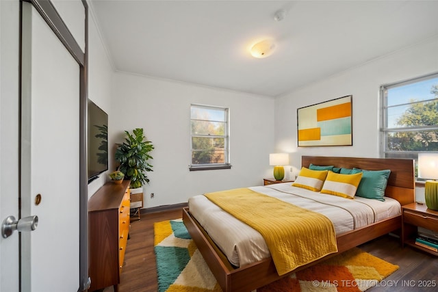 bedroom with dark wood-type flooring and ornamental molding