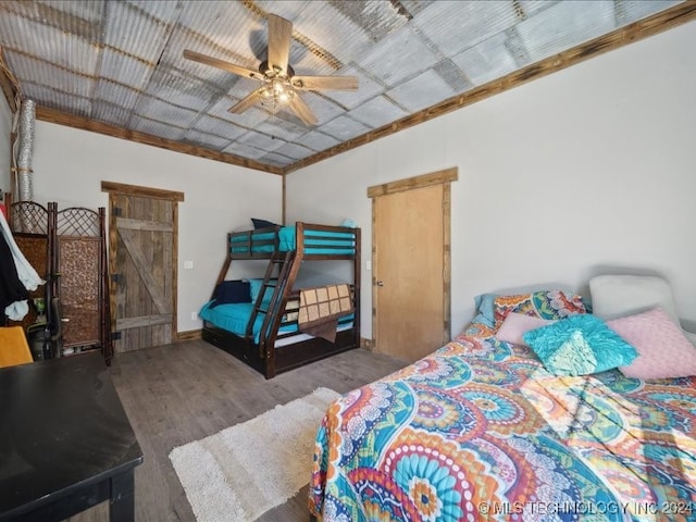 bedroom with ornamental molding, hardwood / wood-style flooring, and ceiling fan