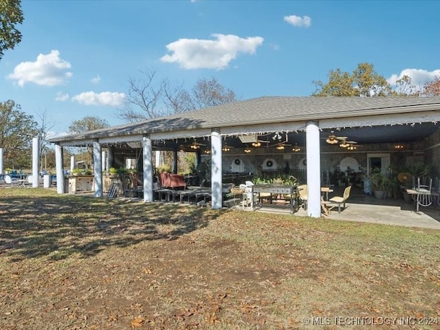 view of community featuring a yard and a patio