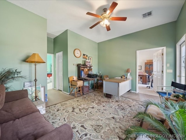 carpeted living room with ceiling fan