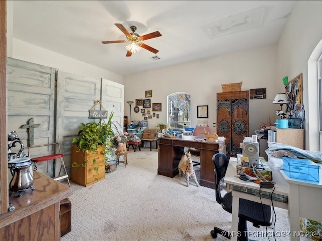 carpeted office featuring ceiling fan