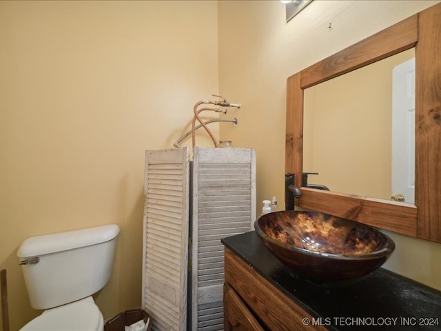 bathroom with toilet and vanity