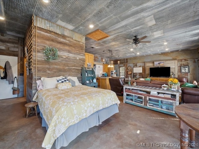 bedroom featuring wood walls and concrete floors