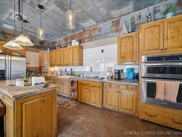 kitchen with stainless steel appliances, light stone countertops, pendant lighting, sink, and a center island