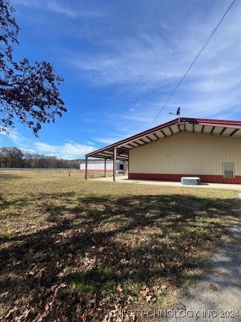 view of side of property with a lawn