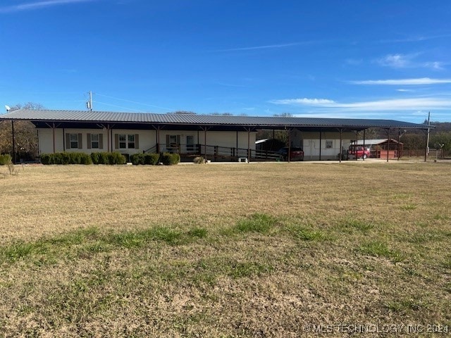 rear view of property with a yard