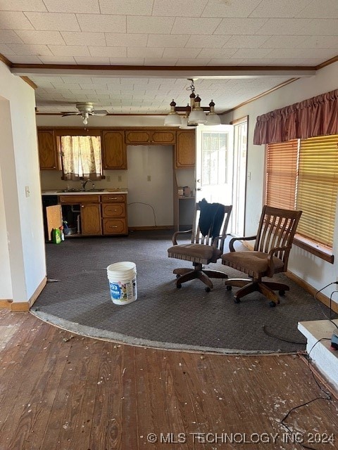 unfurnished living room with hardwood / wood-style flooring, beamed ceiling, and crown molding