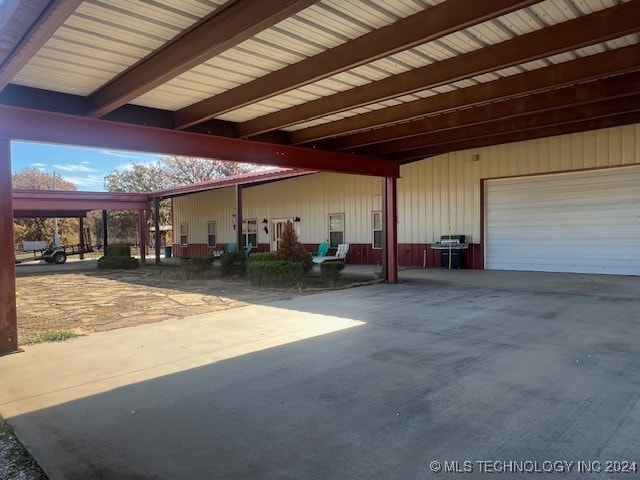 view of patio / terrace with a garage and a carport