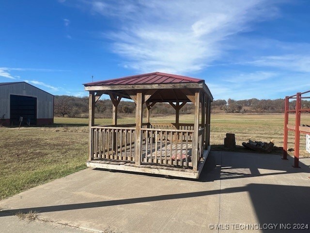 exterior space with an outdoor structure, a lawn, and a gazebo