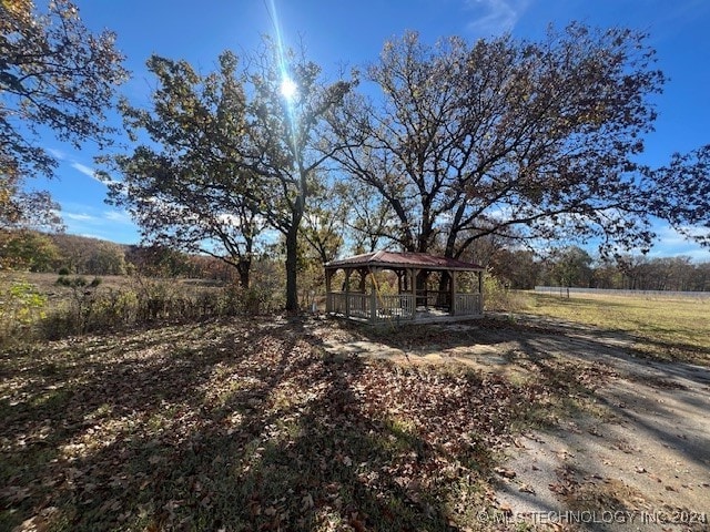 view of yard featuring a rural view and a gazebo